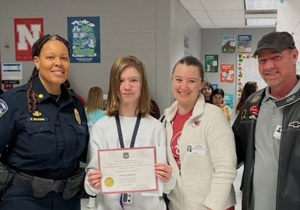 Essay Contest Winner – West Side – 3rd Place – Anthony Diamond Bingham Middle School Pictured L to R: MPOA member Major Nicole Walters (Lee’s Summit PD), Anthony, Stephanie (mother), and Timothy (father)