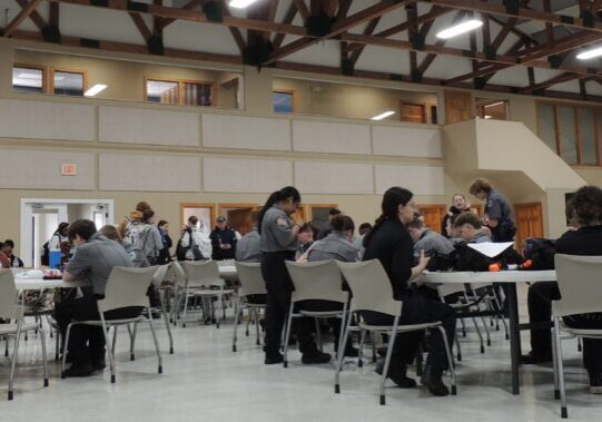 Officers and trainees sitting at tables talking